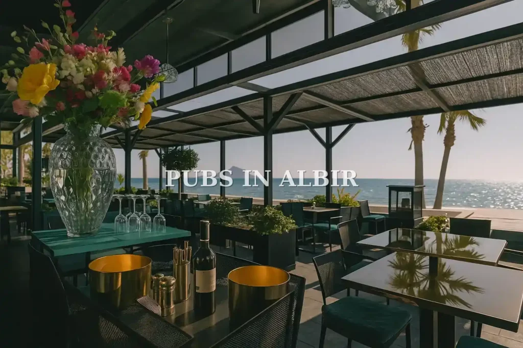 Vista de un pub elegante en El Albir con decoración moderna, mesa preparada con copas y flores, y vistas al mar y a la montaña